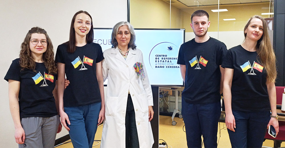 Profesionales de ucrania junto a la dra. María Ramiro, luciendo unas camisetas con las banderas de Ucrania y España.